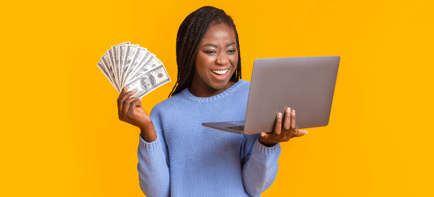 Girl, smiling, holding a lot of money bills she earn on IoT Monetization and selling mobile data with her smart devices. She is holding a laptop to see her additional revenue